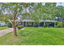 Charming single-story home with a well-maintained lawn and mature landscaping at 1708 Pond Lake Dr, Tampa, FL 33612