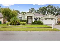 Charming single-story home with well-maintained landscaping and attached two-car garage at 3725 Grand Forks Dr, Land O Lakes, FL 34639