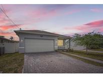 Charming single-story home featuring a gray brick driveway and a spacious two-car garage at 5047 23Rd St N, St Petersburg, FL 33714