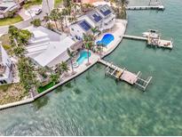 Stunning waterfront home featuring a pool, spa, and private dock with boat lift and gulf access at 980 Boca Ciega Isle Dr, St Pete Beach, FL 33706