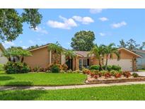 Charming single-story home with stone accents, lush landscaping, and a well-manicured lawn at 2567 Frisco Dr, Clearwater, FL 33761