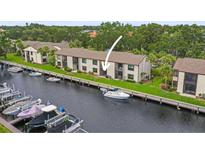 Waterfront condos with boat docks and lush landscaping provide access to the water and outdoor enjoyment at 358 Moorings Cove Dr # 4B, Tarpon Springs, FL 34689