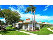 Charming home with well-manicured lawn, mature tree, and two tall palm trees at 4359 Tahitian Gardens Cir # A, Holiday, FL 34691