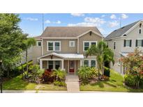 Charming two-story home featuring well-maintained landscaping and a welcoming red front door at 5955 Caldera Ridge Dr, Lithia, FL 33547