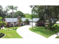 Charming single Gathering home with a well-manicured lawn and inviting curb appeal in a quiet neighborhood at 713 Rustic Oaks Dr, Palm Harbor, FL 34684