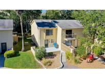 Charming townhome with a small balcony and well-maintained landscaping, offering a cozy curb appeal at 9027 Pebble Creek Dr, Tampa, FL 33647