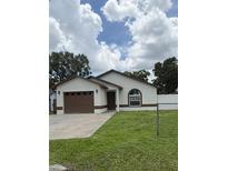 Charming single-story home showcasing a well-maintained lawn and a classic architectural style at 1900 W Kirby St, Tampa, FL 33604