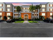 Exterior view of a modern condo building with well-maintained landscaping and a private parking area at 7903 Seminole Blvd # 2203, Seminole, FL 33772