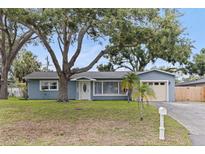 Charming single-story home with mature trees, a well-manicured lawn and a one-car garage at 11451 82Nd Ave, Seminole, FL 33772