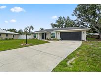 Charming single-story home with a well-maintained lawn and a long driveway leading to a two-car garage at 7108 14Th Nw Ave, Bradenton, FL 34209