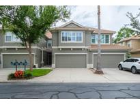 Charming two-story townhome with attached garages and well-manicured landscaping at 3298 Covered Bridge W Dr, Dunedin, FL 34698