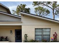 Charming home exterior featuring a well-manicured lawn and stucco facade at 3610 54Th W St # B8, Bradenton, FL 34209