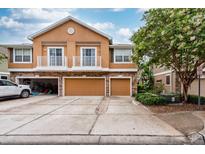 Townhome featuring private garages, balconies, and stone accents at 7001 Interbay Blvd # 121, Tampa, FL 33616
