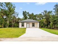 Charming single-story home featuring a well-maintained lawn and private driveway at 18146 Sinatra Ave, Port Charlotte, FL 33954