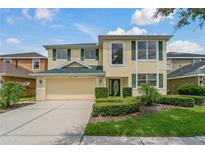 Charming two-story home featuring a manicured lawn, two car garage, and vibrant yellow stucco at 20115 Nob Oak Ave, Tampa, FL 33647