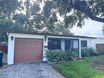 Charming single-story home featuring a one car garage and mature landscaping in front at 3234 37Th N St, St Petersburg, FL 33713