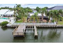 Waterfront property with a private dock and boat lift, offering direct access to the open water at 3921 E Eden Roc Cir, Tampa, FL 33634
