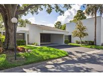 Modern home with a covered carport, xeriscaped yard and mature shade trees at 4104 Northmeadow Cir # 4104, Tampa, FL 33618