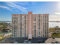 A high-rise condo building with many balconies overlooking beautiful blue skies and calm water at 4900 Brittany S Dr # 1011, St Petersburg, FL 33715