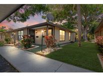 Charming condo featuring a well-maintained front yard and inviting landscaping at 1980 Tahitian Pl # 10, Dunedin, FL 34698