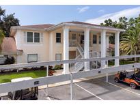 Well-maintained two-story home with mature landscaping, featuring a stairwell and covered parking at 316 Kelsey Way # 316, Sun City Center, FL 33573
