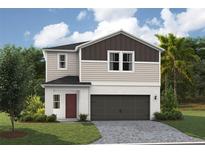 Charming two-story home showcasing a classic design, a well-manicured lawn and a two-car garage at 36828 Sagemoor Dr, Zephyrhills, FL 33541