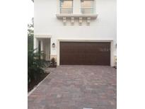 Modern home exterior with a two-car garage at 7814 Hidden Creek Loop # 104, Lakewood Ranch, FL 34202