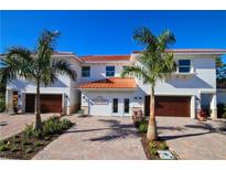 Two story home with attached garage and landscaping at 7780 Hidden Creek Loop # 101, Lakewood Ranch, FL 34202