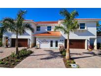 Modern two-story home with two car garage and palm trees at 7730 Hidden Creek Loop # 102, Lakewood Ranch, FL 34202