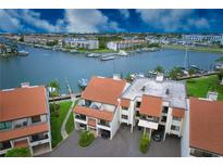 Aerial view of waterfront property with boat slips and canal access at 128 1St E St # 203, Tierra Verde, FL 33715