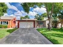 Cute two-story home with a two-car garage and well-maintained lawn at 4451 Tidal Pond Rd, New Port Richey, FL 34652