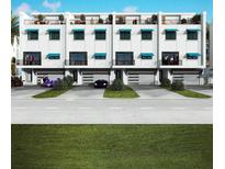 Modern three-story townhomes with attached garages and private balconies at 11605 1St E St # A-4, Treasure Island, FL 33706