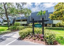 Rosemount Lodge condo building with landscaping at 36750 Us Highway 19 N # 21305, Palm Harbor, FL 34684