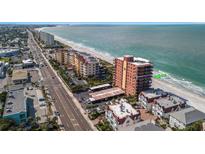 Breathtaking aerial view of the condo complex and beach with pristine blue waters and a bright blue sky at 15316 Gulf Blvd # 604, Madeira Beach, FL 33708