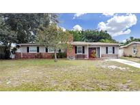 Brick ranch house with mature landscaping at 4004 W Coachman Ave, Tampa, FL 33611