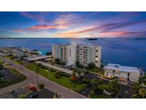 Aerial view of waterfront condo building at sunset at 200 Woodette Dr # Tr-B 102W, Dunedin, FL 34698