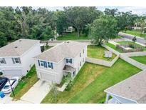 Aerial view of a two-story house with a backyard and surrounding homes at 10913 Trailing Vine Dr, Tampa, FL 33610