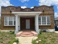 Spanish style home with a pink front steps at 2117 W Cass St, Tampa, FL 33606