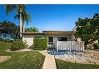 Front view of single story condo with small fenced patio at 180 Ingrid Pl, Oldsmar, FL 34677