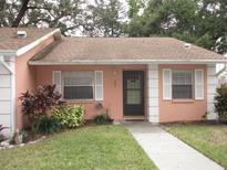 Quaint peach-colored house with a well-maintained lawn and walkway at 2250 Druid E Rd # 605, Clearwater, FL 33764