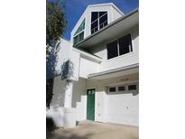 White two story home with green door and attached garage at 9720 Indian Key Trl # 117, Seminole, FL 33776