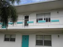 Building exterior featuring teal accents and balconies at 1921 58Th N Ave # 22, St Petersburg, FL 33714