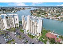 High-rise condo building with parking and water views at 9415 Blind Pass Rd # 1103, St Pete Beach, FL 33706