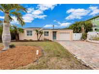 Charming bungalow style home with a brick driveway at 16110 3Rd E St, Redington Beach, FL 33708