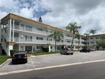 Front view of a condo building with parking at 2431 Canadian Way # 9, Clearwater, FL 33763