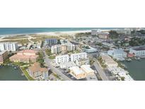 Aerial view of beachside community, showcasing multiple buildings at 11605 1St E St # 6, Treasure Island, FL 33706