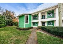 Charming green condo building with walkway and landscaping at 2525 Royal Pines Cir # 26-A, Clearwater, FL 33763