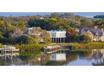 Breathtaking waterfront home featuring modern architecture, a private dock, and lush landscaping at 1761 Oceanview Dr, St Petersburg, FL 33715
