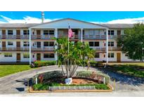 Two-story building exterior with palm trees and landscaping at 6015 19Th N St # 308, St Petersburg, FL 33714