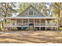 Two-story house with wraparound porch and large yard at 3136 Neff Lake Rd, Brooksville, FL 34602